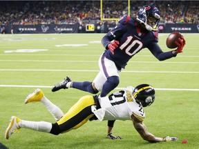 Houston Texans wide receiver DeAndre Hopkins makes a one-handed touchdown catch over Pittsburgh Steelers cornerback Joe Haden during the fourth quarter of an NFL football game, Monday, Dec. 25, 2017 in Houston. The Steelers defeated the Texans 34-6.