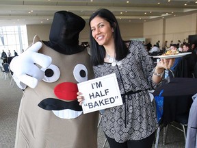 Melissa Muscedere (right), a volunteer coordinator with In Honour of the Ones We Love, poses with Tommy Tater at the charity's Potato Fest in  December 2014.