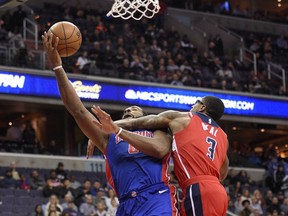 Washington Wizards guard Bradley Beal (3) fouls Detroit Pistons center Andre Drummond (0) during the first half of an NBA basketball game Friday, Dec. 1, 2017, in Washington.
