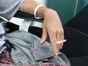 A patient at Windsor Regional Hospital's Met Campus smokes a cigarette in a designated area in August 2017. As of Jan. 1, 2018, smoking will be illegal on all hospital property, under Ontario law.