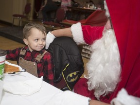 Konnor Harding, 5, gets some special Santa attention at a free Christmas Day dinner hosted by Windsor's Dahl family at the Masonic Temple, Dec. 25, 2017.