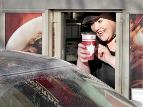 Friendly Tim Hortons server Amina Khiat greets a customer at the Windsor Timmys on Wyandotte Street East at Marentette Avenue, Jan. 5, 2018.