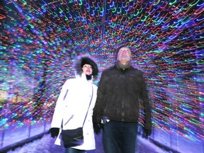 On a chilly night, Ernie and Catherine Nikita of Essex walk through one of the light tunnels at Bright Lights Windsor at Jackson Park on Jan. 5, 2018.