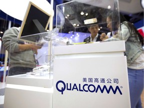 In this Thursday, April 27, 2017, file photo, visitors look at a display booth for Qualcomm at the Global Mobile Internet Conference (GMIC) in Beijing. BlackBerry Ltd. (TSX:BB) and Qualcomm Technologies, Inc. say they will collaborate to develop technology for the next generation of connected vehicles.
