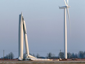 A wind turbine sits in a twisted heap following a collapse in a field Friday, Jan. 19, 2018, on the 16th Line near Drake Road, southeast of Merlin, Ont.