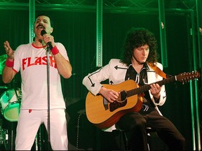 Members of the Queen cover band Simply Queen perform during a concert.