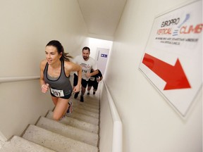 Shanna Komsa is followed by Dan Zukiwsky as she runs up the stairs at One Riverside Drive West during the Vertical Climb presented by Europro on Jan. 21, 2018. The event raises money for the neurosciences program at the Ouellette Campus of Windsor Regional Hospital.