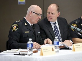 Windsor Police Chief Al Frederick, left, speaks with Windsor Mayor Drew Dilkens during the fourth community meeting in Amherstburg to discuss issues of policing and details about Windsor Police Services proposal at Libro Centre Saturday Jan. 27, 2018.