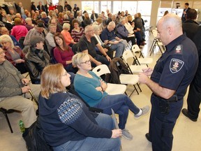 Windsor Police Sgt. Ron LeClair, right, speaks with audience members during the fourth community meeting to discuss issues of policing and details about Windsor Police Services' proposal at the Libro Centre on Jan. 27, 2018.