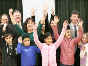 Greater Essex County District School Board director of education Erin Kelly, rear left, and Parkview public school principal Dave Simone, rear right, cheer with Grade 4-5 students and other board officials during the announcement Wednesday of a new Eastwood/Parkwood public school to be located on Wildwood Drive near Holly Crescent in Forest Glade.