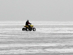 An ATV rider travels on the ice of Lake St. Clair in Belle River in this 2007 file photo.