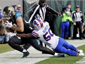 Jacksonville Jaguars tight end Ben Koyack (83) takes a pass in the end zone while being defended by Buffalo Bills outside linebacker Ramon Humber (50) in the second half of an NFL wild-card playoff football game in Jacksonville, Fla., Sunday, Jan. 7, 2018. Jacksonville won 10-3.