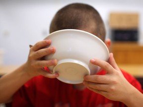 Regan Green, 8, a grade three student at Prince Edward Public School, digs into his breakfast cereal while attending the breakfast program at Prince Edward Public School on Oct. 23, 2013.  The breakfast program feeds students breakfast and snacks in order to give them a good healthy start to their day.