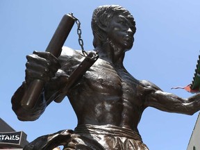 A statue of Bruce Lee wielding a pair of nunchaku in downtown Los Angeles in 2013.