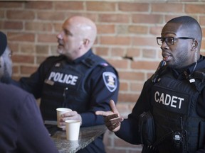 Cadet Abraham Nyamadi of the Windsor Police Service, enjoys coffee and chit chat at The Coffee Exchange for Coffee with a Cop, Thursday, Jan. 18, 2018.