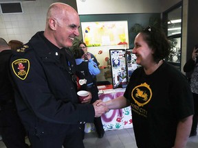Chief of Windsor Police Al Frederick shakes hands with Gillian Benoit, a resident of the Drouillard Road area, at a 'Coffee With a Cop' event at the Gino A. Marcus Community Centre in March 2017.