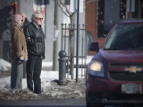 Walkerville residents Elaine Weeks and Chris Edwards wait to cross busy Wyandotte Street East at Chilver Road, Tuesday, Jan. 9, 2018, where Coun. Chris Holt has requested funds to put a crosswalk.