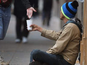 A man solicits money in downtown Windsor on Oct. 13, 2017.