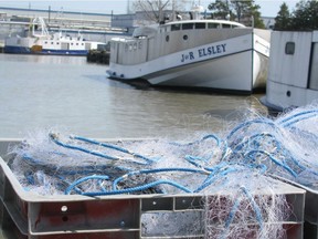 Fishing nets sit beside boats at the Wheatley harbour  in this 2010 file photo.