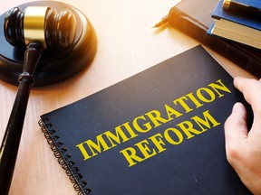 A document calling for immigration reform and a gavel are shown in a photo illustration.