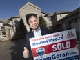 Real estate agent, Goran Todorovic, holds a 'sold' sign outside of 13970 Riverside Dr. E. in Tecumseh on Friday, Jan. 26, 2018.