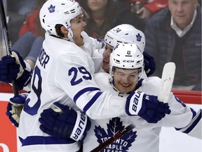 Toronto Maple Leafs center William Nylander, left, celebrates with center Auston Matthews and defenseman Connor Carrick after scoring on a penalty shot against Chicago Blackhawks goalie Jeff Glass during the overtime period of an NHL hockey game, Jan. 24, 2018, in Chicago. The Toronto Maple Leafs defeated the Chicago Blackhawks 3-2 in overtime.
