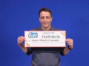 Maurice Thibeault holds up his $3-million prize cheque at the Ontario Lottery and Gaming Corporation's Prize Centre in Toronto on Jan. 4, 2018. Thibeault's dispute with his ex-girlfriend over another $3 million in winnings continues.