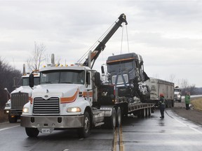 A transport truck is loaded onto a flatbed after being involved in a collision with a pickup truck on Highway 3 between Graham Side Rd. and Highway 18 on Jan. 22, 2018.