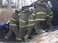 Tecumseh firefighters free a male driver who was trapped after a collision with a dump truck on Howard Ave. in Oldcastle, Thursday, Jan. 18, 2018.  The male driver was trapped for nearly 45 minutes before being taken to hospital with undisclosed injuries.