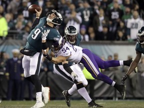 Philadelphia Eagles quarterback Nick Foles throws as he's hit by Minnesota Vikings' Eric Kendricks during the first half of the NFL football NFC championship game Sunday, Jan. 21, 2018, in Philadelphia.