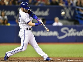 FILE - In this Aug. 15, 2017, file photo, Toronto Blue Jays' Josh Donaldson hits a three-run home run against the Tampa Bay Rays during the fifth inning of a baseball game in Toronto. The hot corner figures to be smoking Friday, Jan. 12, 2018, when players and team swap proposed salaries in arbitration. Donaldson, Baltimore's Manny Machado, Washington's Anthony Rendon and the Chicago Cubs' Kris Bryant were among the more than 170 players headed to the exchange.