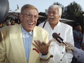 In this Aug. 25, 1992 file photo, Jerry Van Dyke, left, and his brother, Dick, laugh during a party in Los Angeles. Jerry Van Dyke, 'Coach' star and younger brother of comedian Dick Van Dyke, died Friday at his ranch in Arkansas at 86 with his wife, Shirley Ann Jones, was by his side.