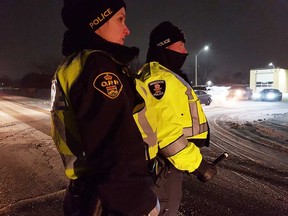An Essex County OPP officer and a Windsor police officer at a RIDE stop in Amherstburg on Dec. 28, 2017.