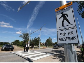 Tecumseh Mayor Gary McNamara, left,  County Warden Tom Bain and active transportation co-ordinator for Essex County Cathy Copot-Nepszy try out the new pedestrian crossing during a news conference on Tuesday, June 27, 2017.