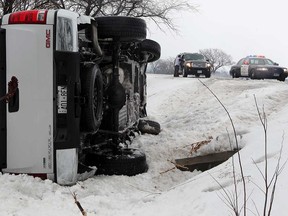 OPP deal with a pickup truck that rolled over on County Road 22 near Patillo Road in Lakeshore in this February 2014 file photo. No one was hurt.