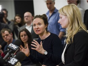 Plaintiff Patricia Fagan (second from right) speaks to press after filing a lawsuit alleging sexual harassment by Soulpepper Theatre Company director Albert Schultz, in Toronto, on Jan. 4, 2018.