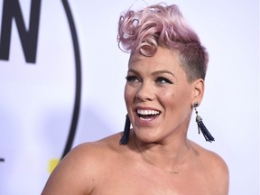 FILE - In this Nov. 19, 2017, file photo, Pink arrives at the American Music Awards at the Microsoft Theater in Los Angeles. NFL announced Monday, Jan. 8, 2018, that the pop star will perform "The Star-Spangled Banner" before the Big Game on Feb. 4 at U.S. Bank Stadium in Minneapolis.