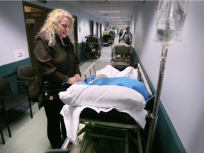 Kelly Koren waits alongside her father in a hallway at the emergency department at the Windsor Regional Hospital Met campus, Jan. 23, 2018. Her father had been waiting 6 hours to be admitted at the time of the photo. Both Met and Ouellette campuses were overcapacity with long wait times in their emergency departments.