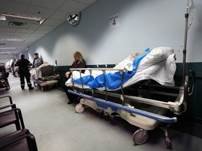 Patients wait in beds lining a hallway at Windsor Regional Hospital's Met Campus on Jan. 23, 2018.