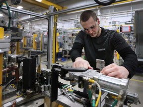 Eric Fabbro, an employee at Centerline Ltd. in Windsor, works on a fabricator in this January 2016 file photo.