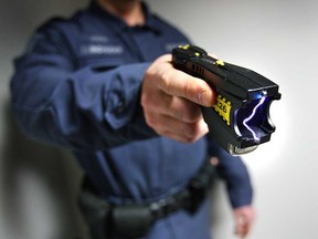 A Windsor police officer demonstrates a Taser X26 conducted energy weapon in this 2008 file photo.