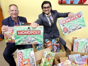 Sam Sinjari, right, a local businessman, has donated 200 new board games to the Windsor-Essex Children's Aid Society. Here Mike Clark, Manager of Public Relations and Fund Development at CAS helps during the press conference on Tuesday Feb. 6, 2018. These will be distributed to families that the society provides services to before Family Day, Monday, Feb. 19.  Sinjari's intent is that the games will be a vehicle for strengthening families by providing an activity that they can all partake and share in together.