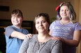 Tabitha Wegner, centre, is pictured in this file photo from last February with   children Gage Diamond, 10, and Nevaeh Diamond, 11, right.