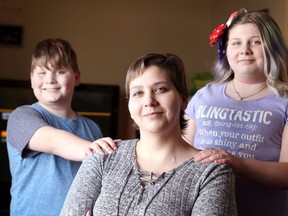 Tabitha Wegner, centre, is pictured in this file photo from last February with   children Gage Diamond, 10, and Nevaeh Diamond, 11, right.