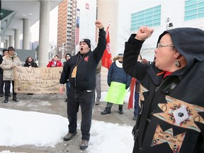 Indigenous speakers Beth Cook, right, and Richard Dalkeith, centre, lead a chant during a Justice for Colten rally and march at downtown Windsor's Ontario Court of Justice building on Chatham Street East, Feb. 13, 2018.