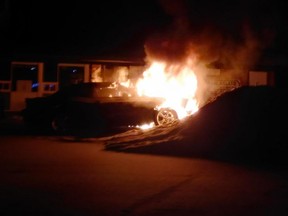 A car is ablaze by Riverside Drive in Tecumseh before the driver was pulled out alive.