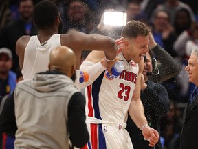 Andre Drummond and teammate Reggie Jackson celebrate Blake Griffin"s first win as a Detroit Pistons at Little Caesars Arena on February 1, 2018 in Detroit, Michigan. Detroit defeated Memphis Grizzlies 104-102.
