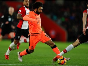 Liverpool's Egyptian midfielder Mohamed Salah runs with the ball during the English Premier League football match between Southampton and Liverpool at St Mary's Stadium in Southampton, southern England on February 11, 2018.