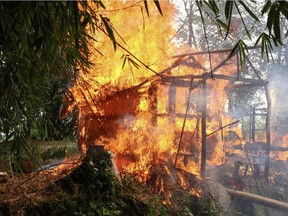 In this Sept. 7, 2017, file photo, a house burns in Rakhine state in northern Myanmar, part of alleged ethnic cleansing efforts targeting Muslim minorities that are being condemned by the international community.