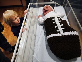 The Super Bowl was celebrated at Windsor Regional Hospital's Met Campus on Sunday, February 4, 2018, as newborn babies received their specially knitted football cocoons. Abigail Churchill, 4, checks out her newborn sister during the event.
